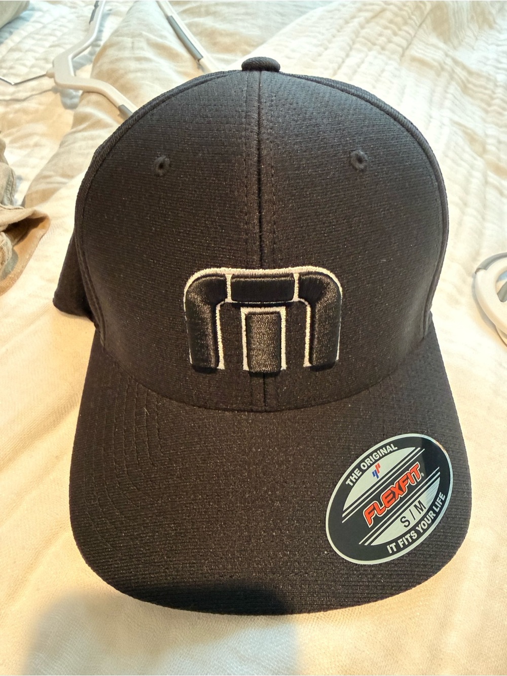 Travis Mathew Black Flexfit Hat with White-Trim Logo
